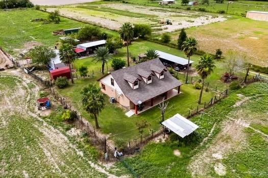 birds eye view of property with a rural view