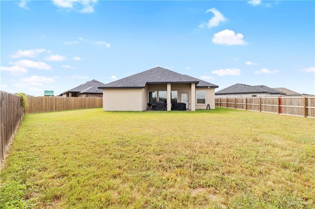 1801 Stardust Ln, Edinburg, TX 78541 - back of house featuring stucco siding, a fenced backyard, and a shingled roof