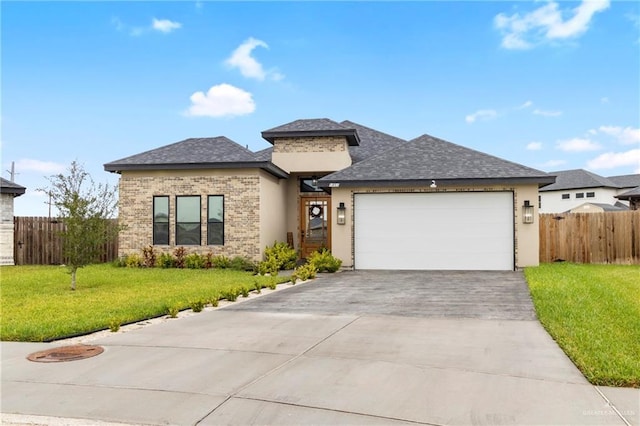 1801 Stardust Ln, Edinburg, TX 78541 - view of front of property with a garage, concrete driveway, roof with shingles, brick siding, and stucco siding