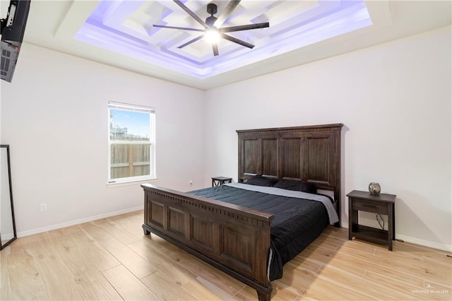1801 Stardust Ln, Edinburg, TX 78541 - bedroom with a raised ceiling, light wood-style floors, and a ceiling fan