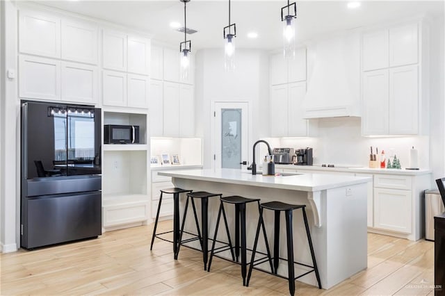 1801 Stardust Ln, Edinburg, TX 78541 - kitchen featuring smart refrigerator, custom range hood, light countertops, light wood-style flooring, and recessed lighting