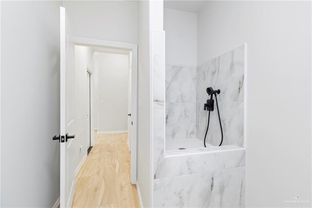 1801 Stardust Ln, Edinburg, TX 78541 - bathroom featuring a marble finish shower and wood finished floors