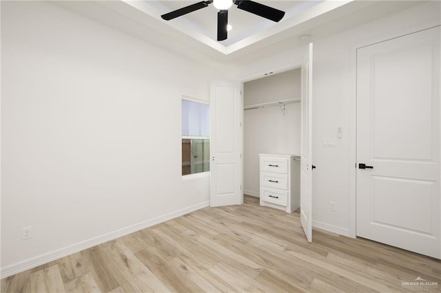 unfurnished bedroom with a closet, light hardwood / wood-style flooring, and ceiling fan