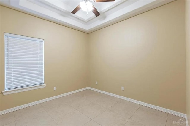 2805 E Garfield Ave, Alton, TX 78573 - spare room with a ceiling fan, a tray ceiling, baseboards, and light tile patterned flooring