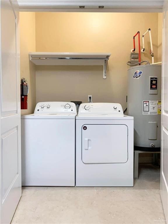 2805 E Garfield Ave, Alton, TX 78573 - laundry area featuring electric water heater and washing machine and dryer