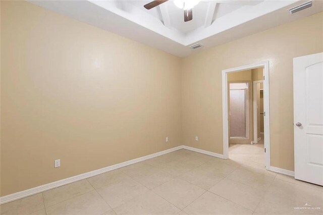 2805 E Garfield Ave, Alton, TX 78573 - unfurnished room featuring ceiling fan, light tile patterned flooring, baseboards, and a raised ceiling