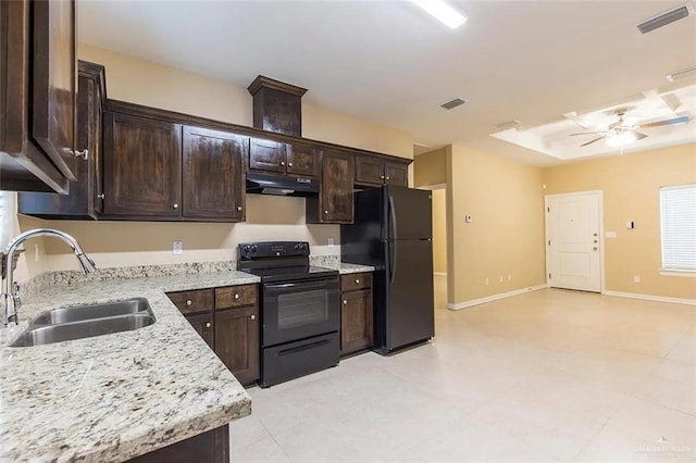 2805 E Garfield Ave, Alton, TX 78573 - kitchen featuring black appliances, a sink, under cabinet range hood, dark brown cabinetry, and light stone countertops