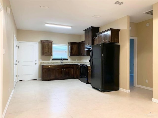 2805 E Garfield Ave, Alton, TX 78573 - kitchen with black appliances, light countertops, exhaust hood, dark brown cabinetry, and a sink