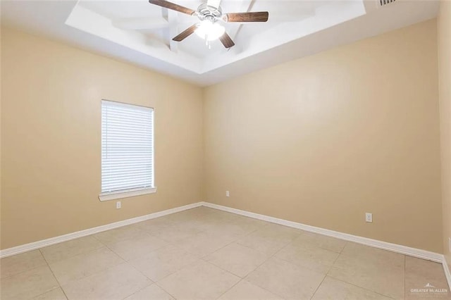 2805 E Garfield Ave, Alton, TX 78573 - empty room with a tray ceiling, baseboards, light tile patterned floors, and ceiling fan