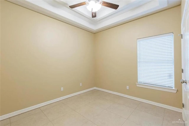 2805 E Garfield Ave, Alton, TX 78573 - empty room featuring a raised ceiling, a ceiling fan, baseboards, and light tile patterned floors