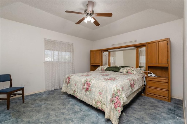 carpeted bedroom with a tray ceiling, baseboards, a textured ceiling, and lofted ceiling