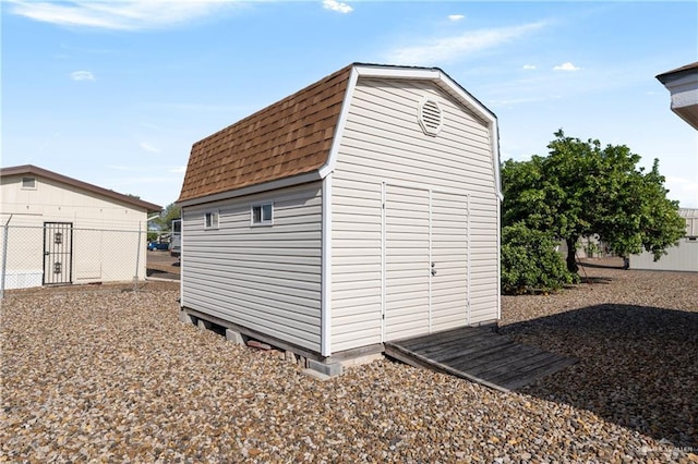 view of shed featuring fence