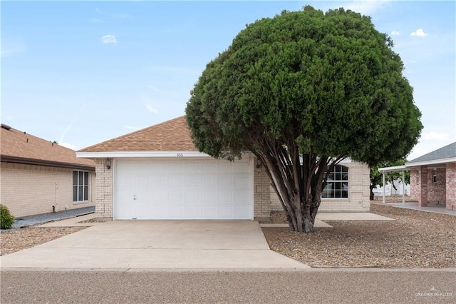 406 Sagittarius St, Mission, TX 78572 - ranch-style house featuring an attached garage, driveway, and brick siding