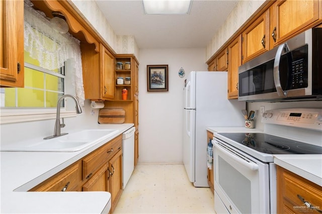 kitchen featuring white appliances, light floors, brown cabinetry, and light countertops