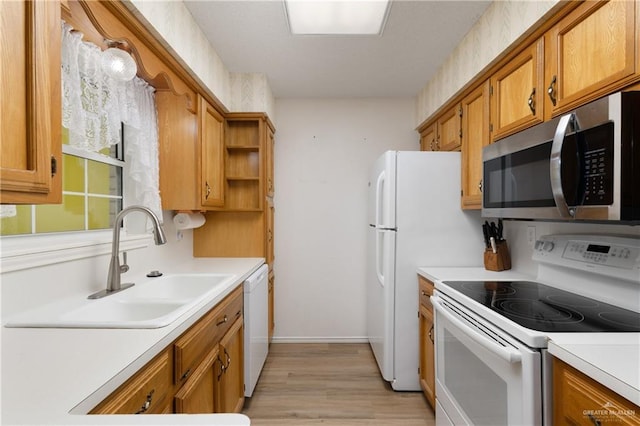 406 Sagittarius St, Mission, TX 78572 - kitchen with white appliances, a sink, light countertops, and light wood-type flooring