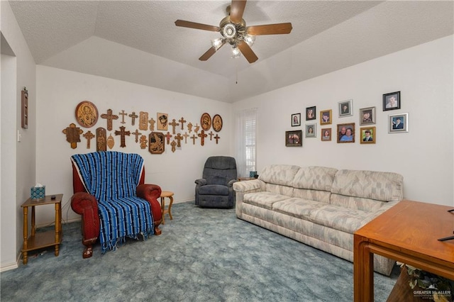 living room with ceiling fan, lofted ceiling, carpet flooring, a textured ceiling, and a raised ceiling