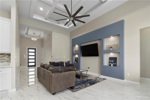 living room with ceiling fan, a towering ceiling, beam ceiling, coffered ceiling, and a raised ceiling