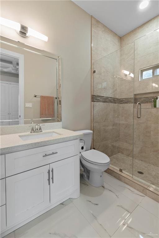 bathroom featuring vanity, toilet, and walk in shower