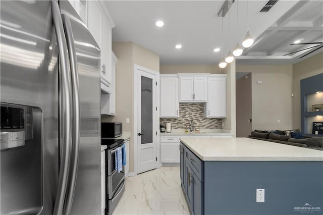 kitchen featuring sink, white cabinetry, tasteful backsplash, hanging light fixtures, and appliances with stainless steel finishes