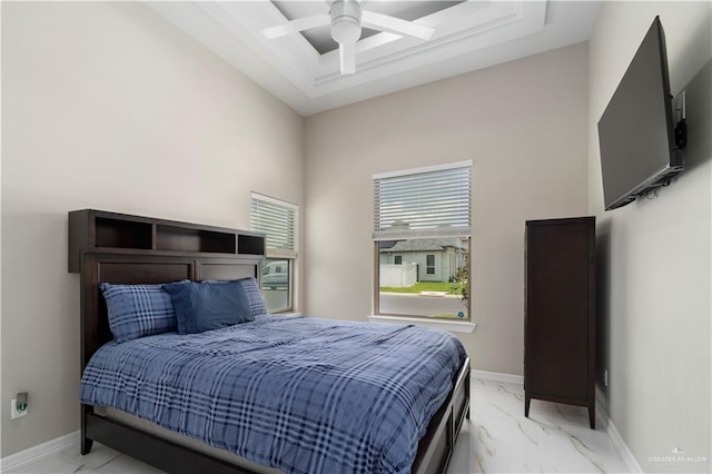 bedroom featuring ceiling fan and a tray ceiling