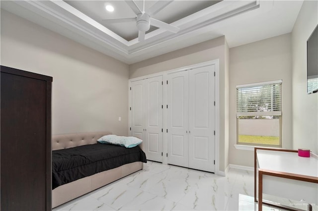 bedroom featuring multiple closets and ceiling fan