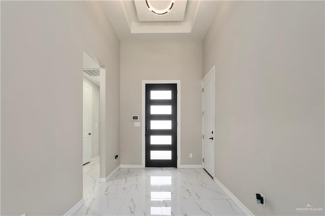 entryway featuring a tray ceiling