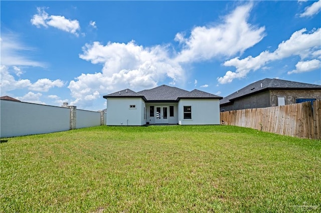 rear view of house featuring a lawn