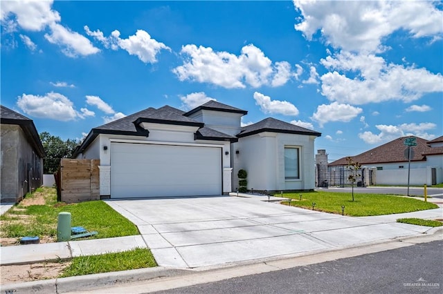 view of front of house with a garage and a front lawn