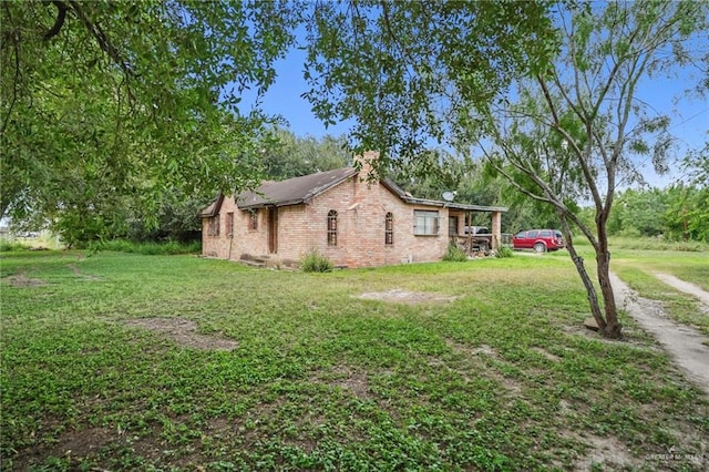 view of side of property with a lawn