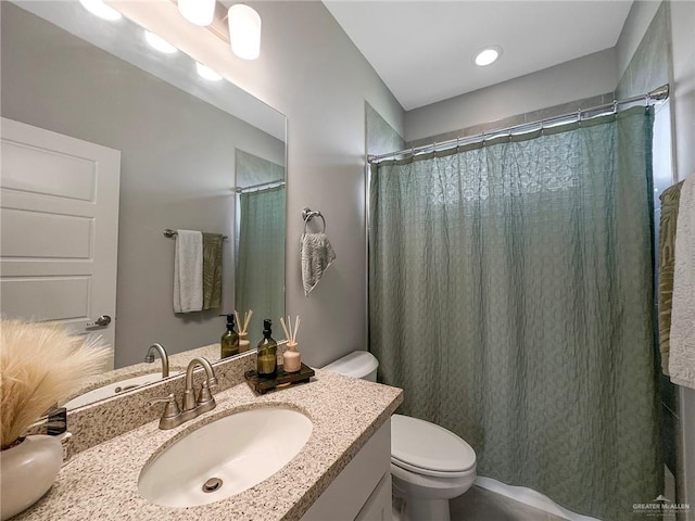 bathroom with vanity, toilet, and curtained shower