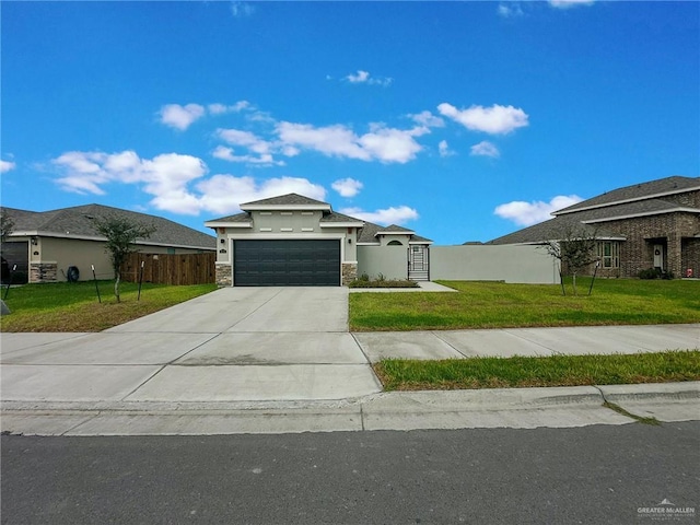 view of front of home with a garage and a front lawn