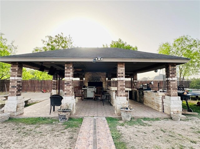 524 S Mile 2 W, Mercedes, TX 78570 - view of patio with a gazebo, a fireplace, and fence