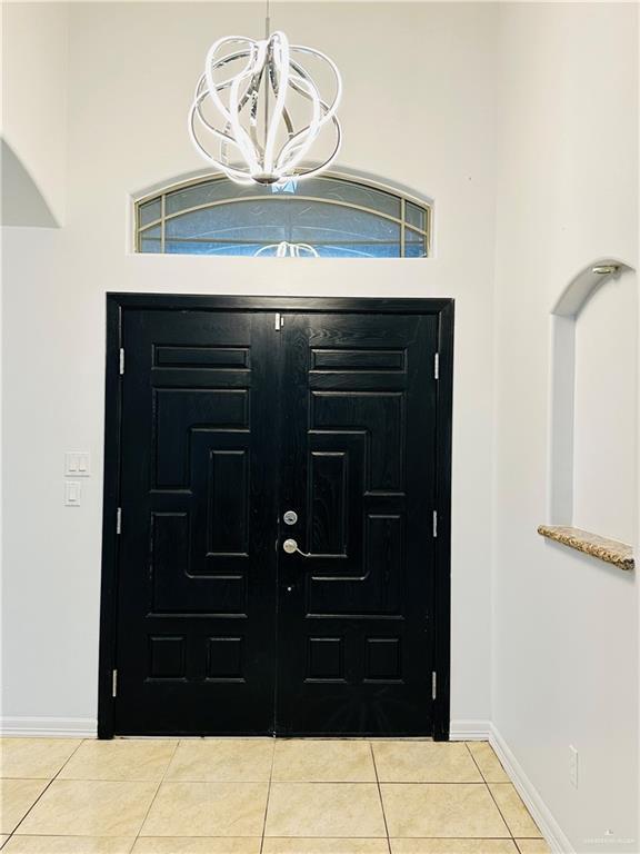 524 S Mile 2 W, Mercedes, TX 78570 - foyer featuring a chandelier, light tile patterned floors, baseboards, and a towering ceiling
