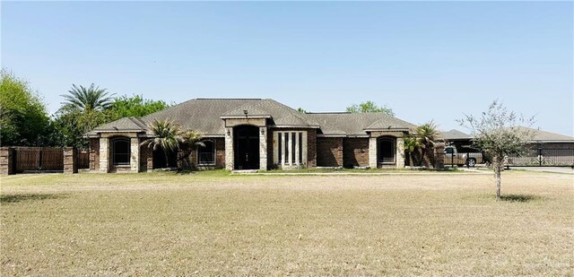 524 S Mile 2 W, Mercedes, TX 78570 - french country inspired facade with a front yard and fence