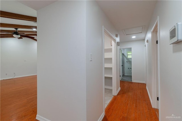 corridor with light wood-style floors, recessed lighting, and baseboards