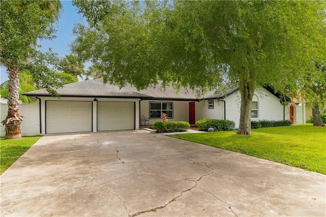 ranch-style house with concrete driveway, a front yard, a garage, and stucco siding