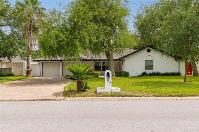 ranch-style home with concrete driveway, a front lawn, and an attached garage