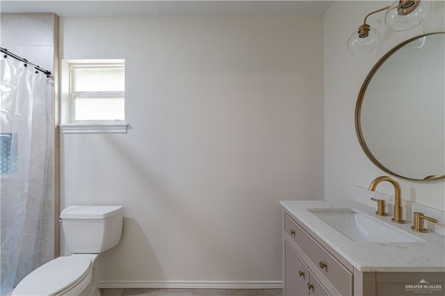 bathroom featuring toilet, vanity, and a shower with shower curtain