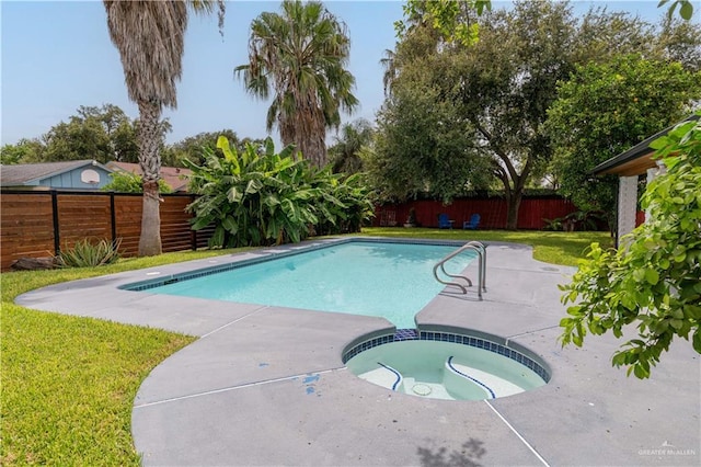 view of swimming pool with a patio area and a pool with connected hot tub