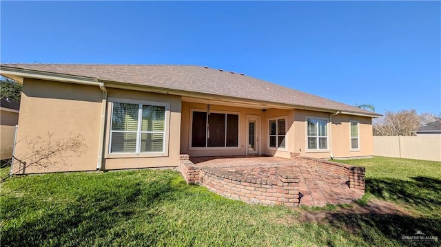 back of house with a patio area, fence, a lawn, and stucco siding