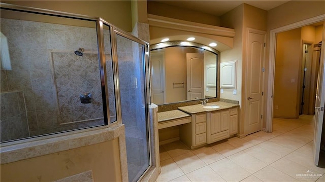 bathroom with a shower stall, tile patterned flooring, and vanity