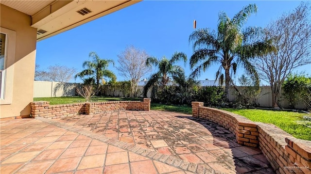 view of patio featuring a fenced backyard and visible vents