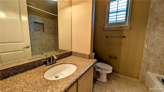 bathroom featuring toilet, tile patterned flooring, vanity, and baseboards