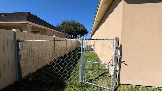 view of home's exterior with a gate, fence, and stucco siding