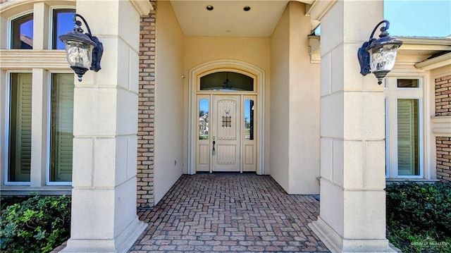 entrance to property with stucco siding