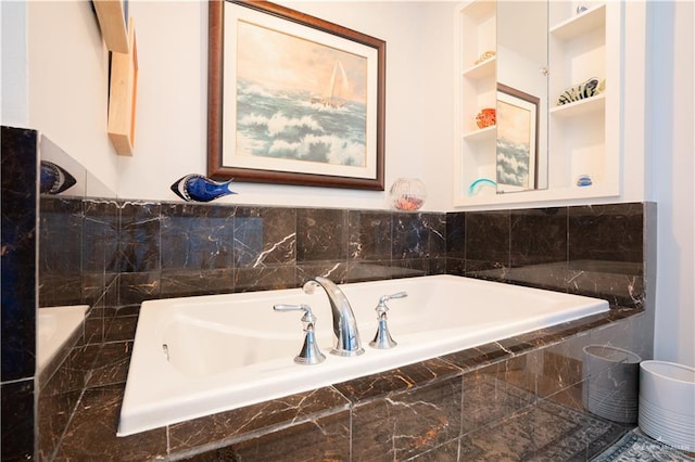 bathroom with a relaxing tiled tub and built in features