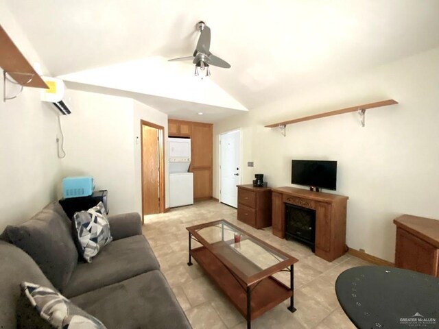 4014 Lark Dr, Mission, TX 78572 - living area featuring an AC wall unit, a ceiling fan, estacked washer and dryer, and lofted ceiling