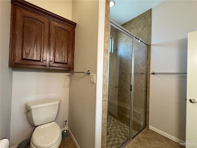 bathroom with toilet, tile patterned flooring, and walk in shower