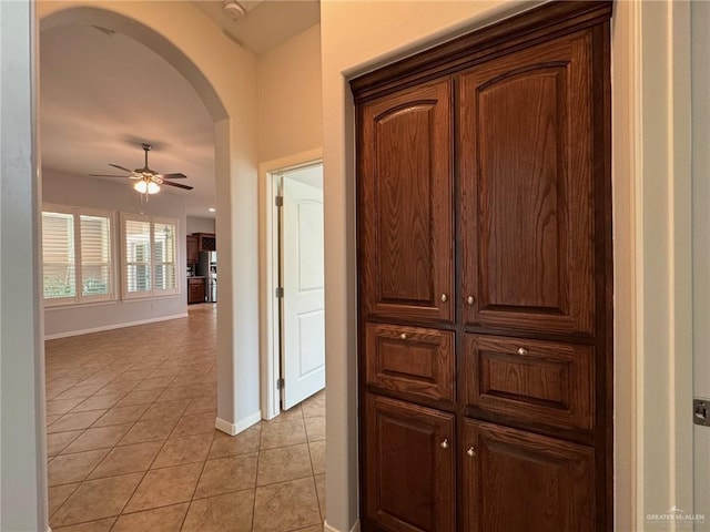 hall featuring light tile patterned floors