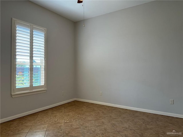 spare room featuring ceiling fan and light tile patterned floors